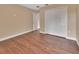 Bedroom with wood floors, neutral paint, double door closet, and ceiling fan at 1226 North St, Daytona Beach, FL 32114