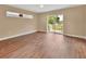 Bright bedroom features wood floors, sliding glass doors to a private balcony, and natural light at 1226 North St, Daytona Beach, FL 32114