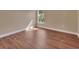 Bedroom features wood floors, neutral paint, and window providing natural light at 1226 North St, Daytona Beach, FL 32114