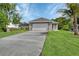 Charming single-story home featuring an attached two-car garage and a well-manicured lawn at 1226 North St, Daytona Beach, FL 32114