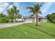Inviting one-story home with a spacious lawn and a palm tree in the front yard at 1226 North St, Daytona Beach, FL 32114