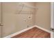 A laundry room with wood flooring and built in wire shelving at 1226 North St, Daytona Beach, FL 32114