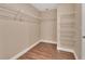 Walk-in closet with metal racking system, neutral paint, and wood floors at 1226 North St, Daytona Beach, FL 32114