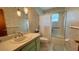 Classic bathroom featuring tile floors, a shower/tub combo with glass doors, and vanity at 1301 Killian St, Daytona Beach, FL 32114