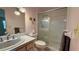 Well-lit pink bathroom with a shower and a single sink vanity at 1301 Killian St, Daytona Beach, FL 32114
