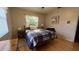 Cozy bedroom featuring hardwood floors, a comfortable bed, and soft, natural lighting at 1301 Killian St, Daytona Beach, FL 32114