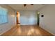 Neutral bedroom with hardwood flooring, a window, and doorways leading to other rooms at 1301 Killian St, Daytona Beach, FL 32114