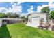 Large backyard with ample green space, storage shed, and patio at 136 W Gardenia Dr, Orange City, FL 32763