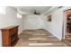 Finished basement with wood-look floors and a fireplace; doorway leads to kitchen at 136 W Gardenia Dr, Orange City, FL 32763