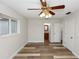 Spacious bedroom boasts wood-look flooring, ample natural light, and ensuite bathroom with walk-in closet at 136 W Gardenia Dr, Orange City, FL 32763