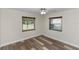 Bright bedroom with wood floors and natural light from two windows at 136 W Gardenia Dr, Orange City, FL 32763