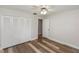 Clean bedroom with wood floors, closet, and a ceiling fan at 136 W Gardenia Dr, Orange City, FL 32763
