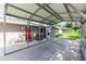 Spacious covered carport with concrete floor and access to the home's entrance at 136 W Gardenia Dr, Orange City, FL 32763