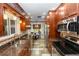 Galley kitchen boasts granite counters, stainless appliances, and cherry wood cabinets at 136 W Gardenia Dr, Orange City, FL 32763