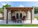 Charming pergola with outdoor seating and decorative lighting, perfect for relaxation at 136 W Gardenia Dr, Orange City, FL 32763