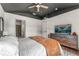 Modern bedroom boasting a stylish ceiling, a mounted TV, and an ensuite bathroom at 1469 Broken Oak Dr # 43A, Winter Garden, FL 34787