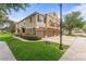 Charming two-story townhome showcasing a well-maintained lawn, landscaping, and attached garages at 1469 Broken Oak Dr # 43A, Winter Garden, FL 34787