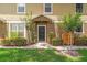 Charming home featuring a well-manicured lawn, lush bushes, and a welcoming front entrance at 1469 Broken Oak Dr # 43A, Winter Garden, FL 34787