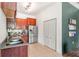 Kitchen includes stainless steel appliances, wooden cabinets, granite countertops, a closet and tile flooring at 1469 Broken Oak Dr # 43A, Winter Garden, FL 34787