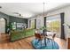 Cozy living area with dark green accent wall, hardwood floors, and comfortable seating with a view of the balcony at 1469 Broken Oak Dr # 43A, Winter Garden, FL 34787