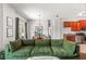 Bright living room with comfortable seating, stylish rug, hardwood flooring, and a view into the kitchen and dining area at 1469 Broken Oak Dr # 43A, Winter Garden, FL 34787