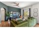 Inviting living room with hardwood floors, green couch, and a balcony offering great views at 1469 Broken Oak Dr # 43A, Winter Garden, FL 34787