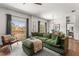 Bright living room with comfortable seating, stylish rug, hardwood flooring, and a view of the balcony at 1469 Broken Oak Dr # 43A, Winter Garden, FL 34787