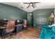 Spacious office featuring wood flooring, accent walls, multiple workstations, and comfortable seating at 1469 Broken Oak Dr # 43A, Winter Garden, FL 34787