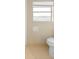 An outdated bathroom featuring a toilet and a window at 1483 Meadowlark Dr, Deltona, FL 32725