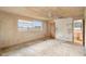 View of the bedroom with a window, ceiling fan, and doorway to the bathroom at 1483 Meadowlark Dr, Deltona, FL 32725