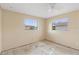 A standard bedroom with two large windows at 1483 Meadowlark Dr, Deltona, FL 32725