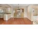 Dining room featuring wood floors, a chandelier, and a view of the kitchen at 1483 Meadowlark Dr, Deltona, FL 32725