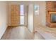 A view of the entry way, adjacent to the living room, and featuring wood laminate flooring at 1483 Meadowlark Dr, Deltona, FL 32725