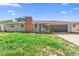 Charming single-story home featuring an attached garage and brick chimney, perfect for comfortable living at 1483 Meadowlark Dr, Deltona, FL 32725