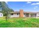 View of house showing brick chimney, gray paint, two windows, and small front yard at 1483 Meadowlark Dr, Deltona, FL 32725