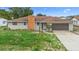 Single-story home featuring an attached garage, complemented by a brick chimney and standard front lawn at 1483 Meadowlark Dr, Deltona, FL 32725