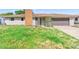 One story gray house with brick chimney, light post, front yard, and attached garage at 1483 Meadowlark Dr, Deltona, FL 32725