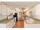 Clean kitchen featuring white appliances, ample countertop space, and practical layout for easy meal preparation at 1483 Meadowlark Dr, Deltona, FL 32725