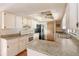 Well-lit kitchen with white cabinets, laminate countertops, and functional appliances, perfect for meal preparation at 1483 Meadowlark Dr, Deltona, FL 32725