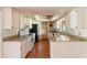 An outdated kitchen featuring white cabinetry, matching appliances, and a ceiling fan at 1483 Meadowlark Dr, Deltona, FL 32725