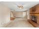 Spacious living room with brick fireplace and ceiling fan at 1483 Meadowlark Dr, Deltona, FL 32725