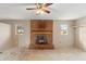 Living room with brick fireplace, ceiling fan, and natural light at 1483 Meadowlark Dr, Deltona, FL 32725