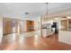 A spacious living room featuring a brick fireplace and access to the kitchen at 1483 Meadowlark Dr, Deltona, FL 32725