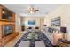 Comfortable living room featuring a brick fireplace, ceiling fan, and coordinated furnishings for relaxing ambiance at 1483 Meadowlark Dr, Deltona, FL 32725