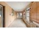 View of the sunroom with windows, sliding glass doors, and wood paneling at 1483 Meadowlark Dr, Deltona, FL 32725