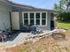 Back patio featuring outdoor seating, greenery, and a Jeep at 1485 Gainsville Dr, Deltona, FL 32725