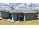 Exterior showing the side and back of the house, with an AC unit and a small patio area at 1485 Gainsville Dr, Deltona, FL 32725