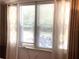 Bedroom window with curtains, blinds, and exterior view of trees at 1485 Gainsville Dr, Deltona, FL 32725