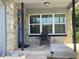 Inviting front porch with stone accents, cozy seating, and a decorative door, perfect for relaxing outdoors at 1485 Gainsville Dr, Deltona, FL 32725