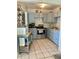 Efficient kitchen featuring updated appliances, ample cabinet space, and a functional rolling island at 1485 Gainsville Dr, Deltona, FL 32725